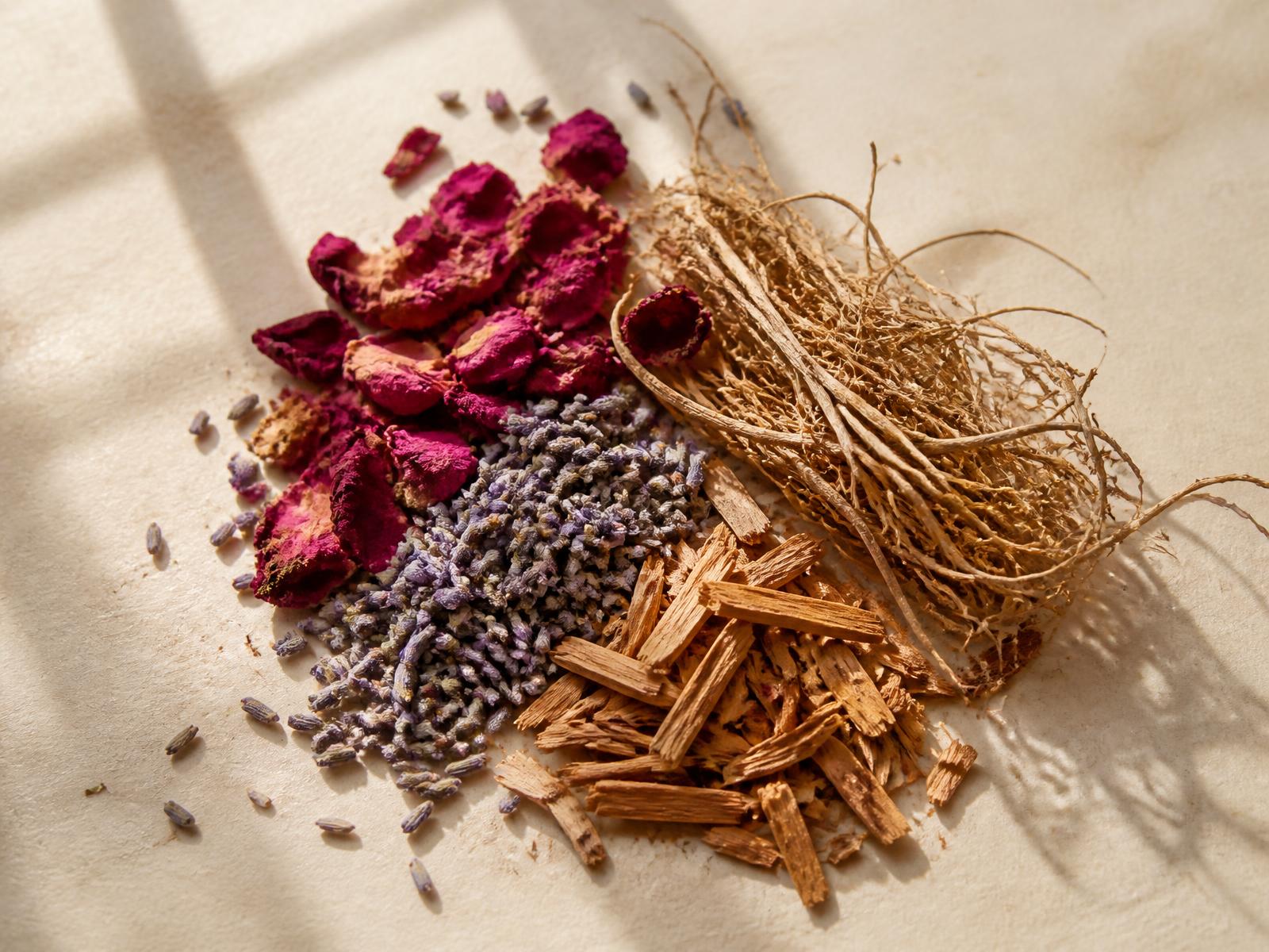 Dried rose petals, lavender buds, sandalwood and vetiver root on ivory paper
